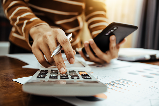 accountant hand making calculations on calculator