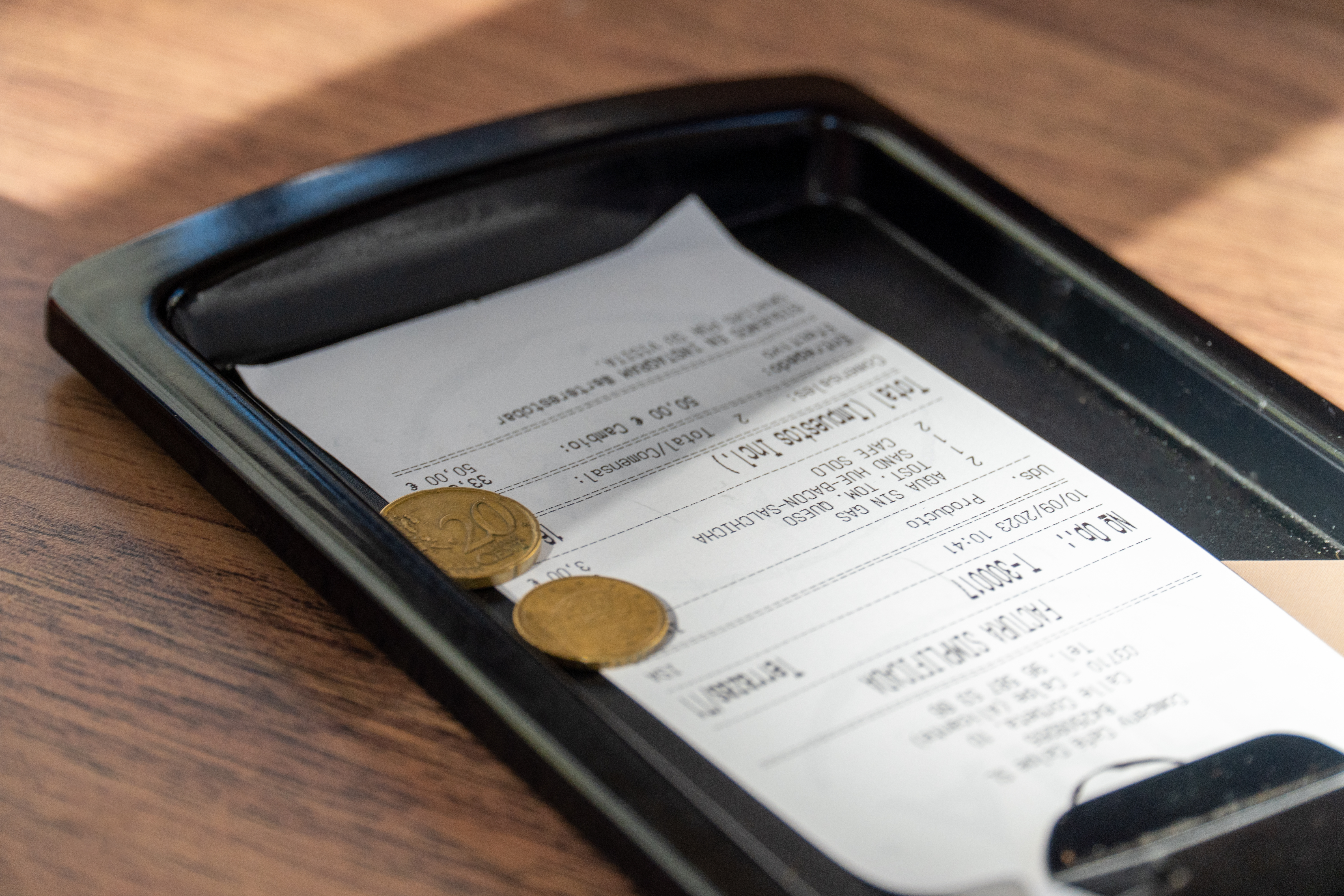 Receipt laying on table with pennies on top