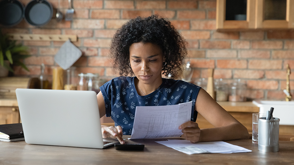 Woman sitting at table with paperwork