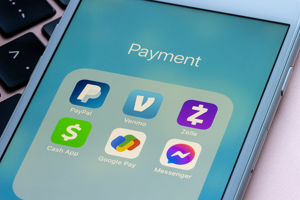 Mobile phone open displaying peer-2-peer payment apps.