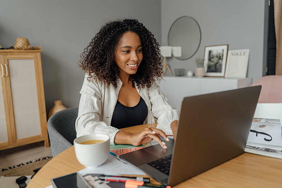 Woman sitting at table working on laptop