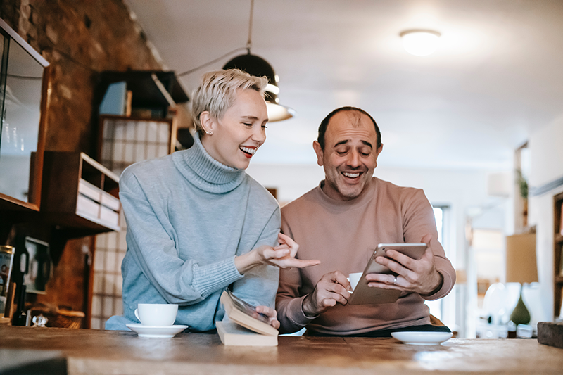 Smiling woman and man sitting in coffee shop