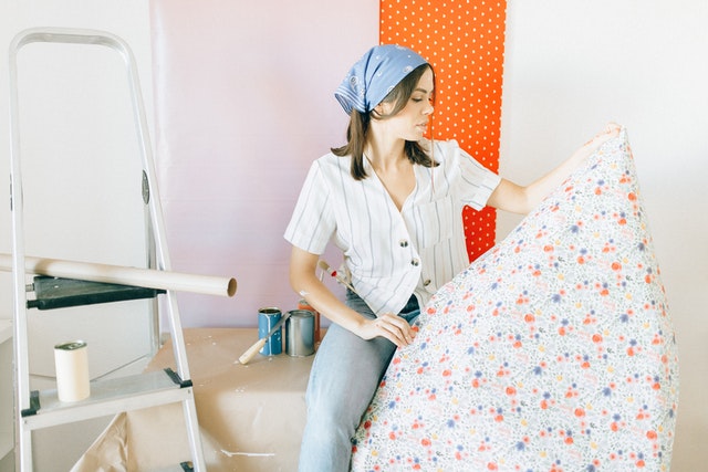 Woman sitting looking at wallpaper