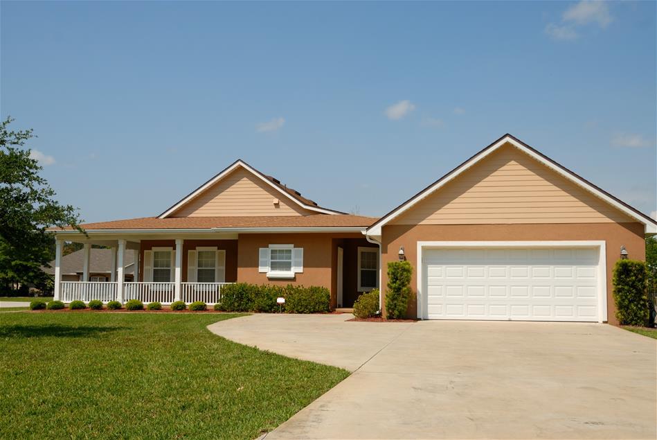 Exterior image of brown house with white trim