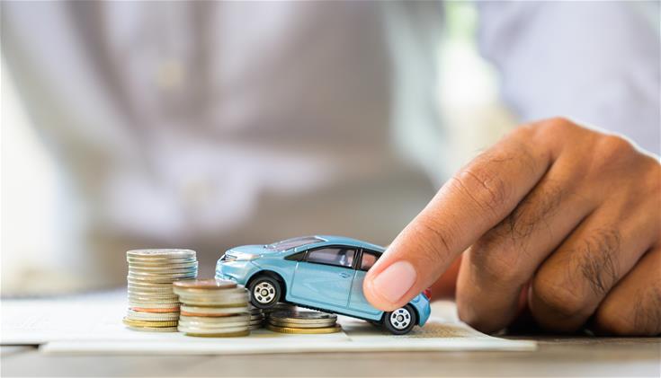 Small blue toy car on coins