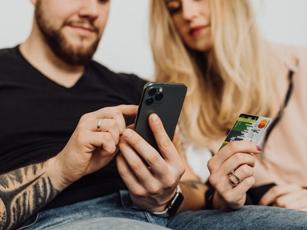 Man and woman with credit card and phone Man and woman with credit card and phone