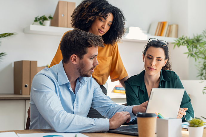 Business people working with laptop and talking ino ffice