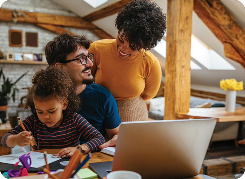 family bonding while daughter draws and father works on computer