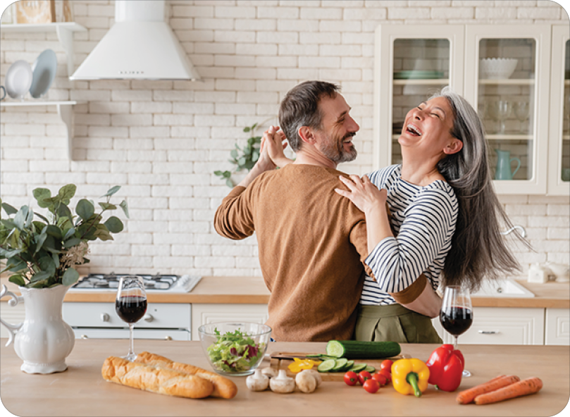 Happy couple dancing together in the kitchen