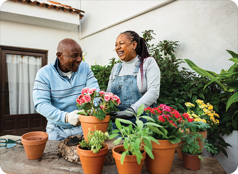 Happy senior couple gardening together at home