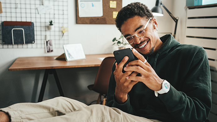 Happy smiling casual man working using mobile phone app