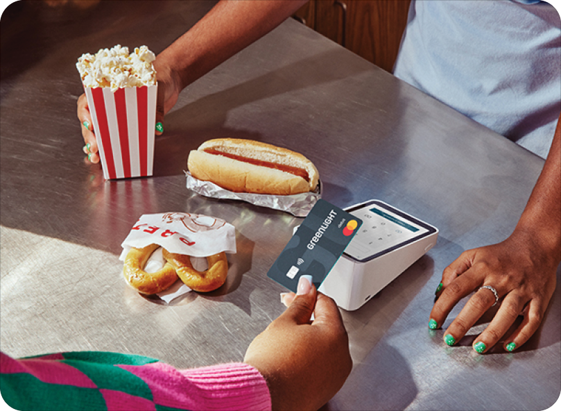 kid paying for concessions with a greenlight card