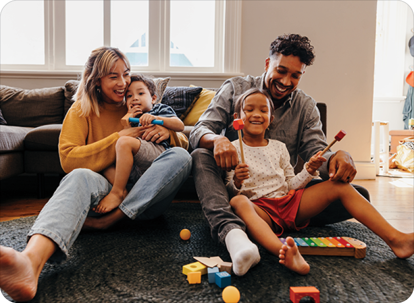 Loving parents having fun with their kids in the living room at home