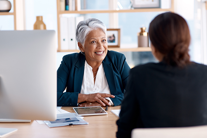 Mature business woman meeting with coworker