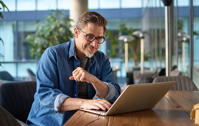 middle age businessman using laptop computer in office
