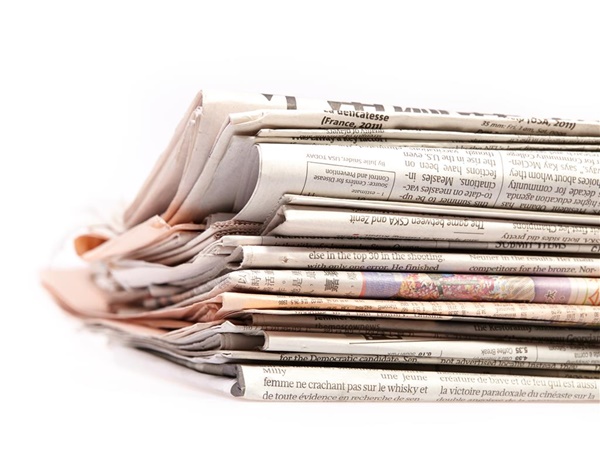 stack of newspapers against white background