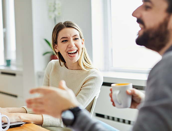 woman laughing while chatting with man