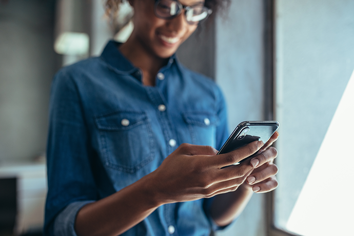 young business woman smiling using mobile phone