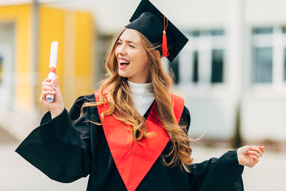 Young woman graduate excited holding diploma