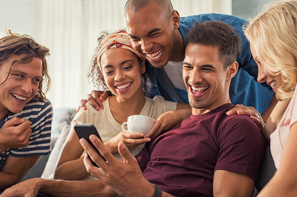 group of friends on couch laughing group of friends on couch laughing