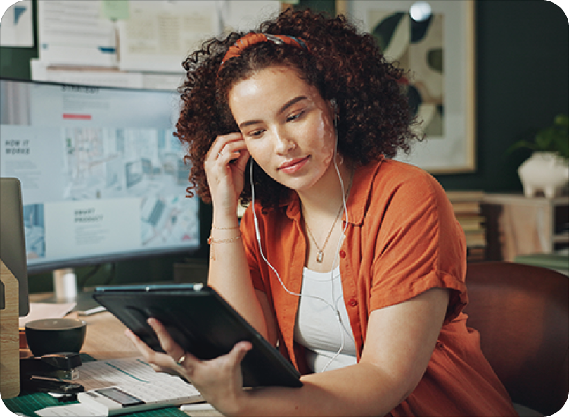 Young woman designer in creative workplace with headphones Young woman designer in creative workplace with headphones